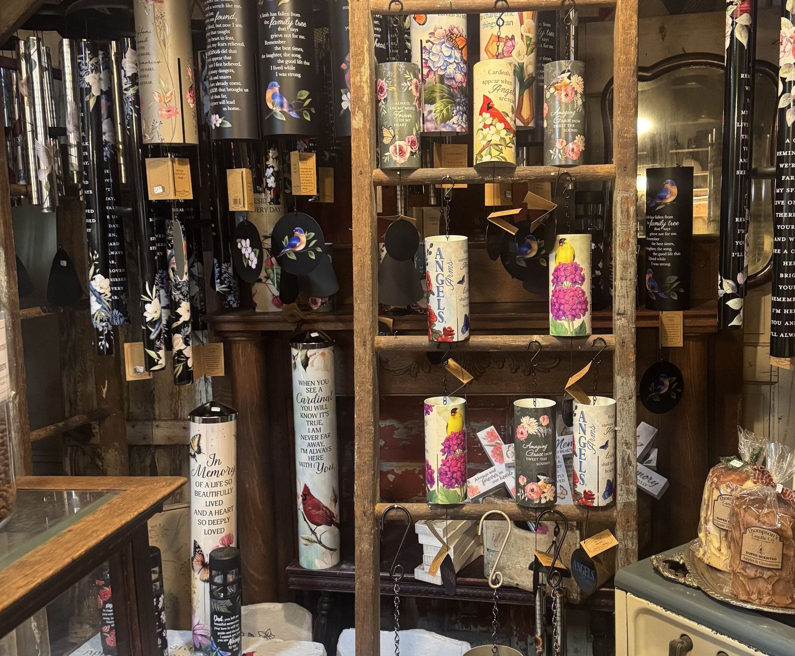 Colorful floral and memorial wind chimes displayed inside Pearls & Lace